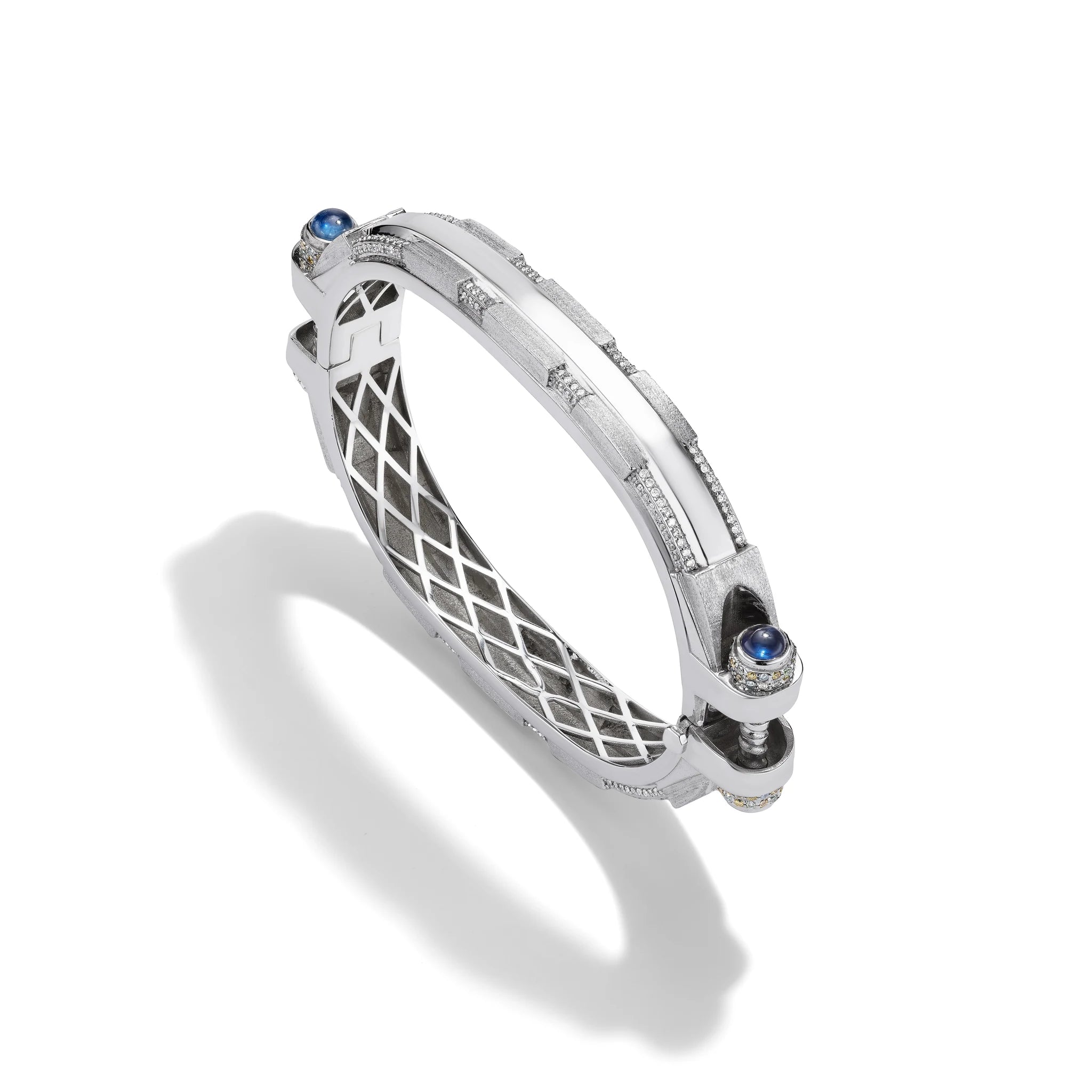 14k white gold Coupling bracelet, angled view with diamond pavé bolt heads, blue sapphire cabochon, white gold lattice.